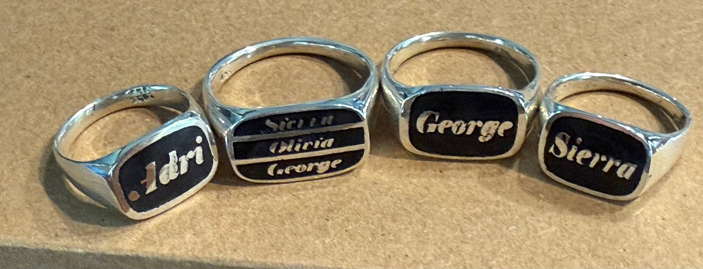 Custom handmade silver signet rings with black background