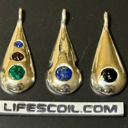 Collection of handmade silver pendants with one, two or three natural stone chips.