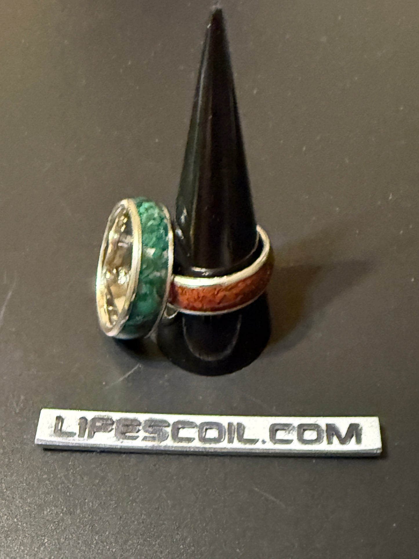 Two handmade silver rings with natural stone, one jasper and one malachite, embedded in band