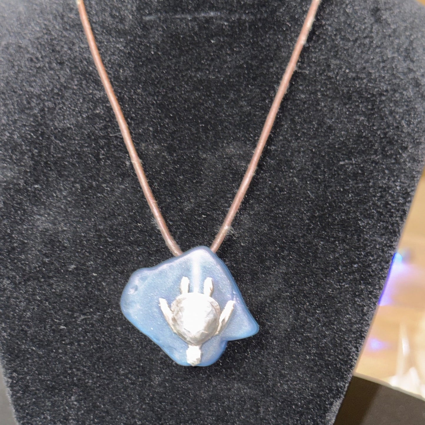 Large light blue sea glass pendant with a silver sea turtle.
