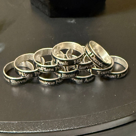 Multiple 14er summit rings in random pile