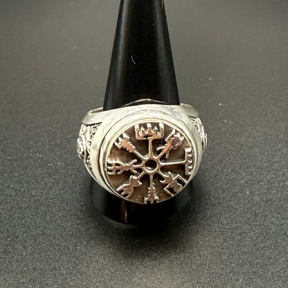 A sterling silver Viking-style ring with a raised compass motif and textured details