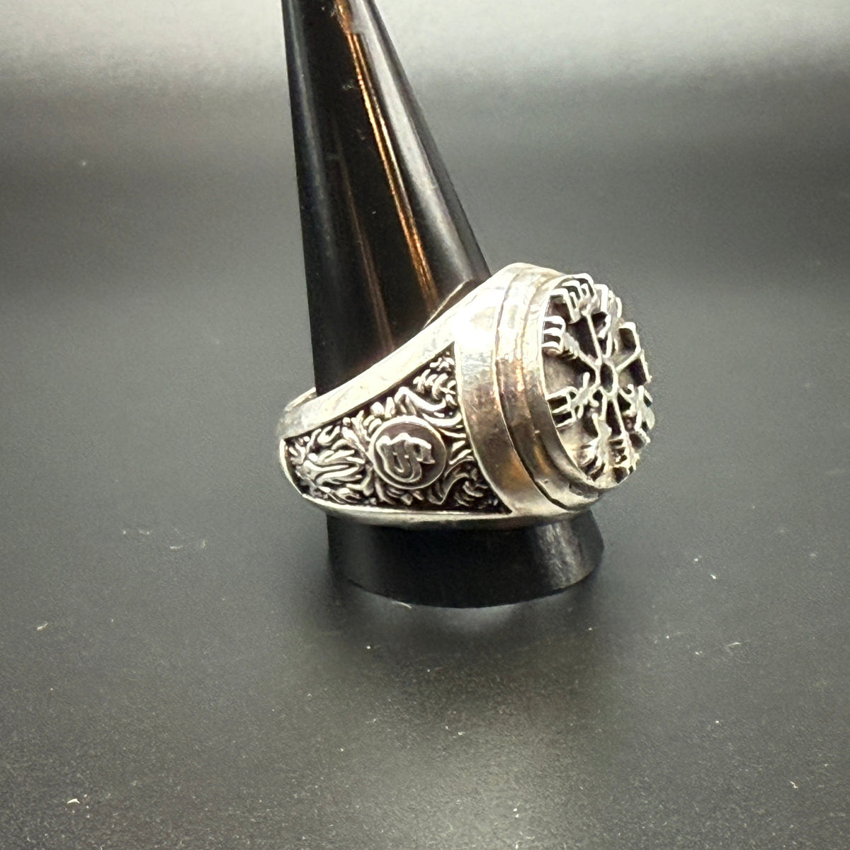 A sterling silver Viking-style ring with a raised compass motif and textured details and customized "S" monogram on side