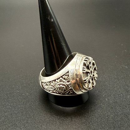A sterling silver Viking-style ring with a raised compass motif and textured details and customized "S" monogram on side