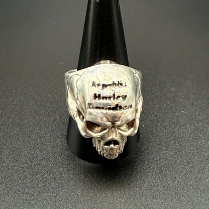 A silver skull ring with 'Republic Harley-Davidson' engraved on the forehead.