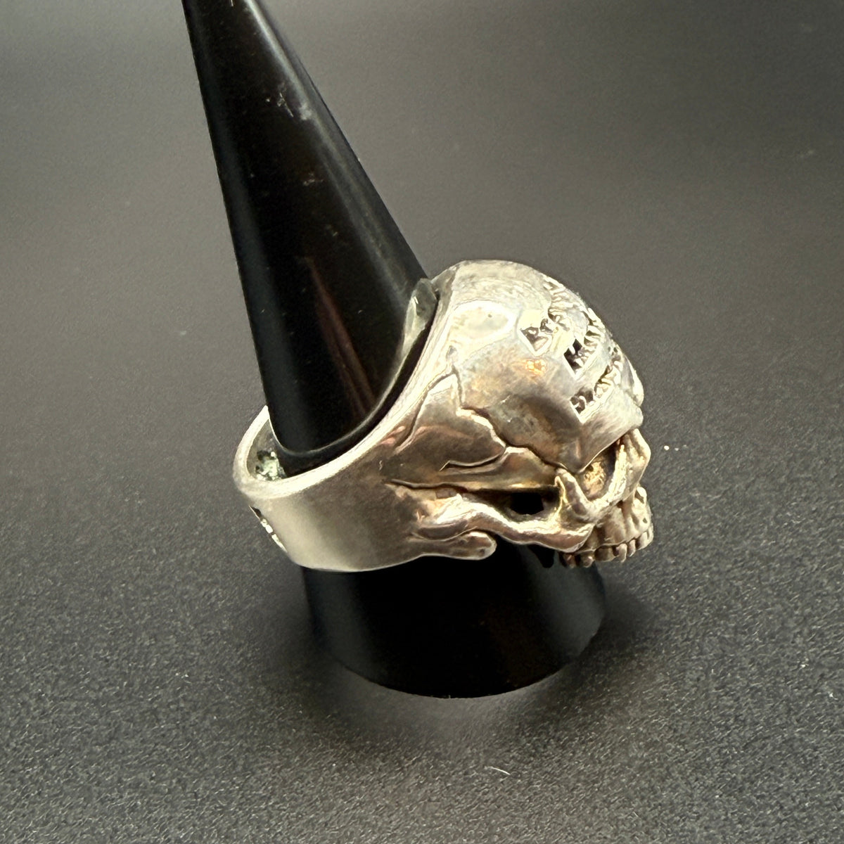 A silver skull ring with 'Republic Harley-Davidson' engraved on the forehead.
