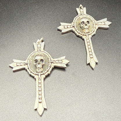 Two sterling silver gothic cross pendants with skull details.