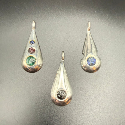 Three sterling silver teardrop pendants with   inlaid natural stones