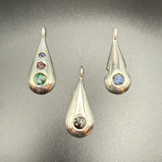Three sterling silver teardrop pendants with   inlaid natural stones