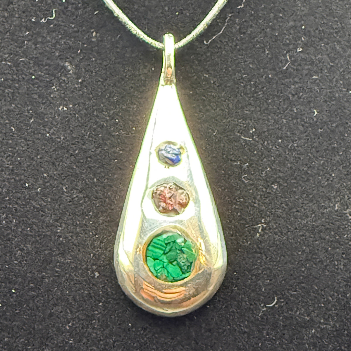 Handmade silver pendant with three natural stone chips and flat edge