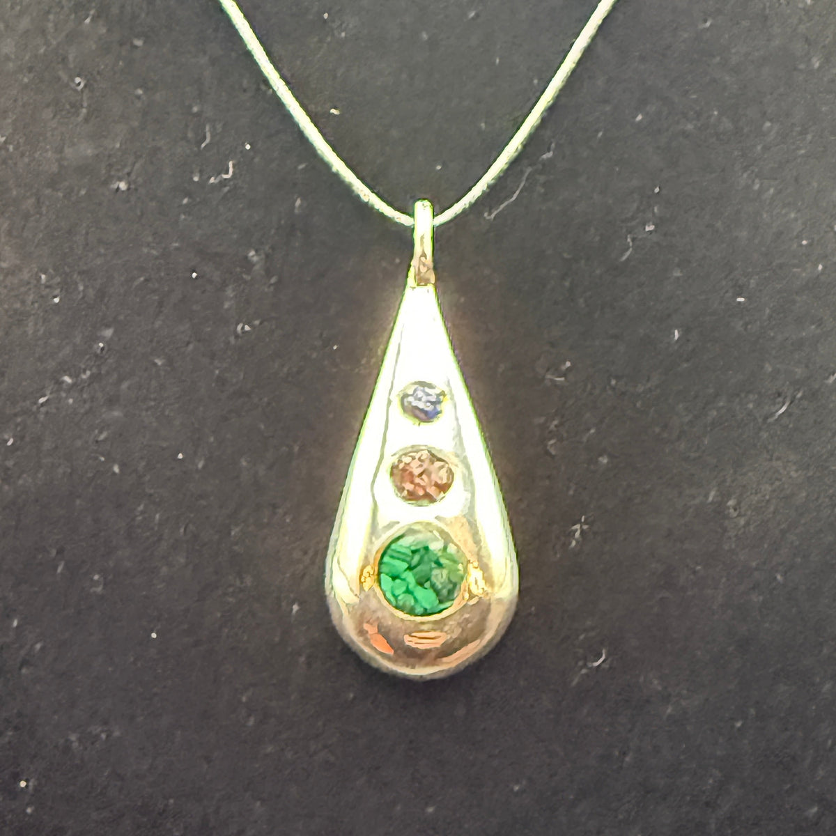 Handmade silver pendant with three natural stone chips and flat edge