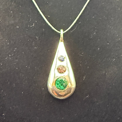 Handmade silver pendant with three natural stone chips and flat edge