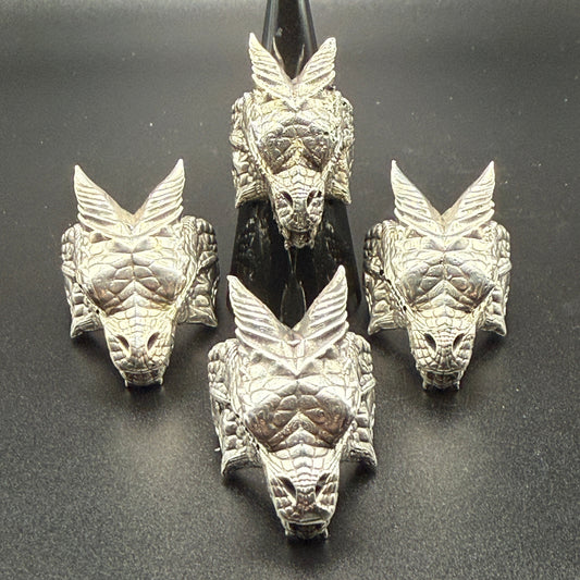 Four silver dragon head rings.