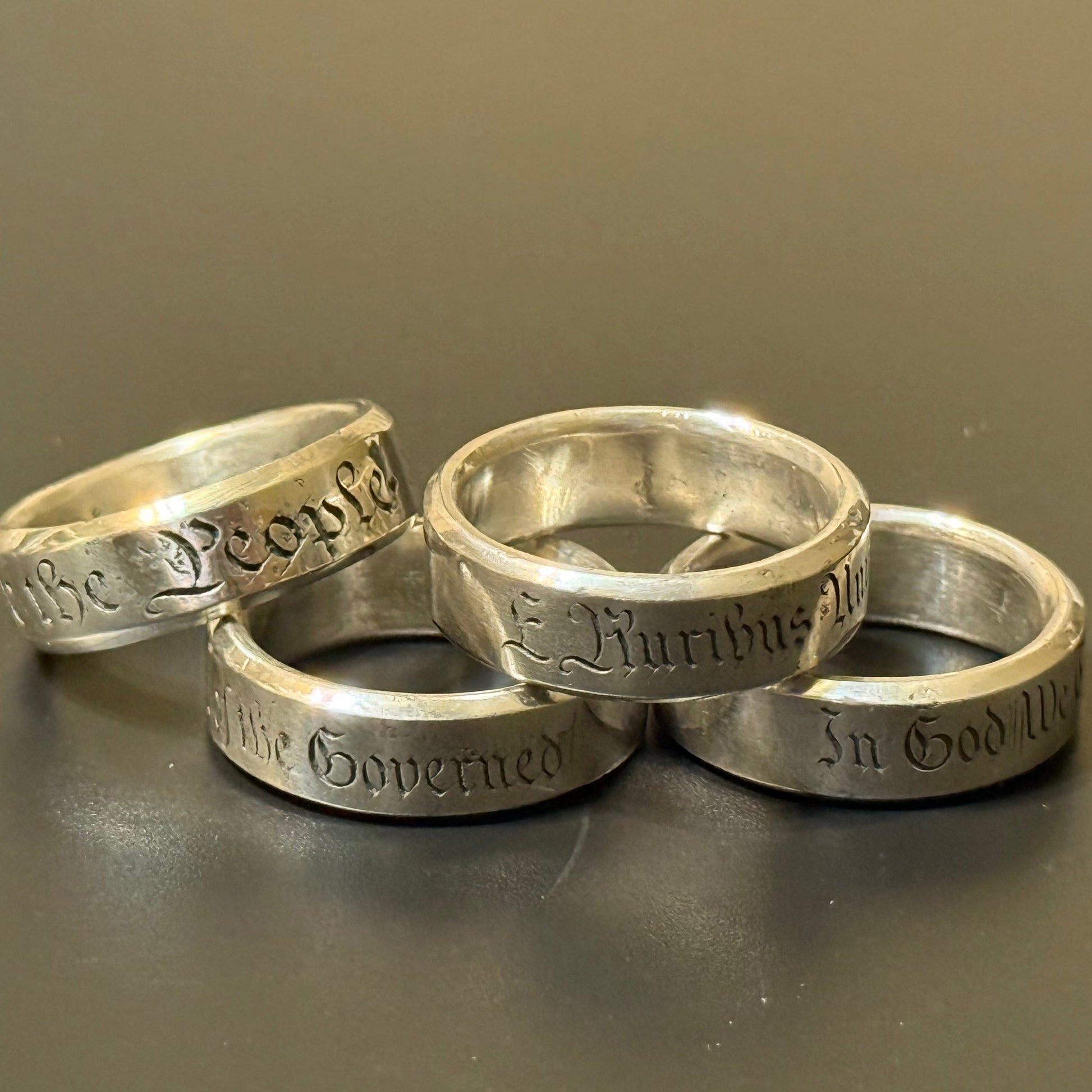 Collection of handmade engraved silver bands with USA Patriot Theme