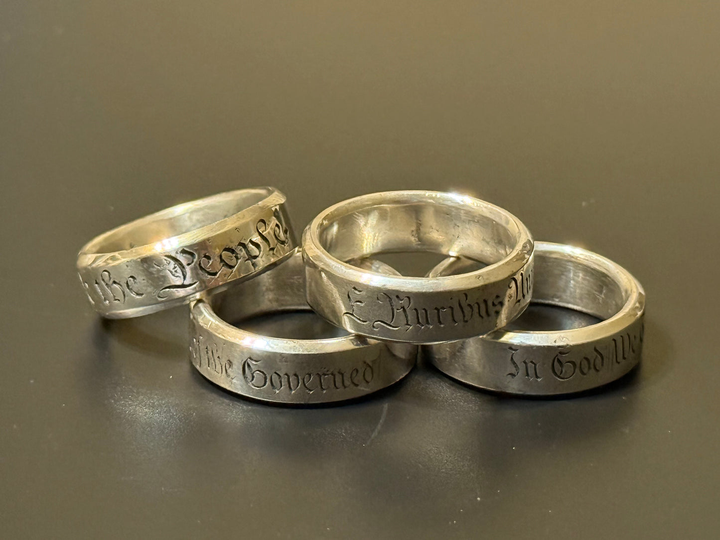 Collection of handmade engraved silver bands with USA Patriot Theme
