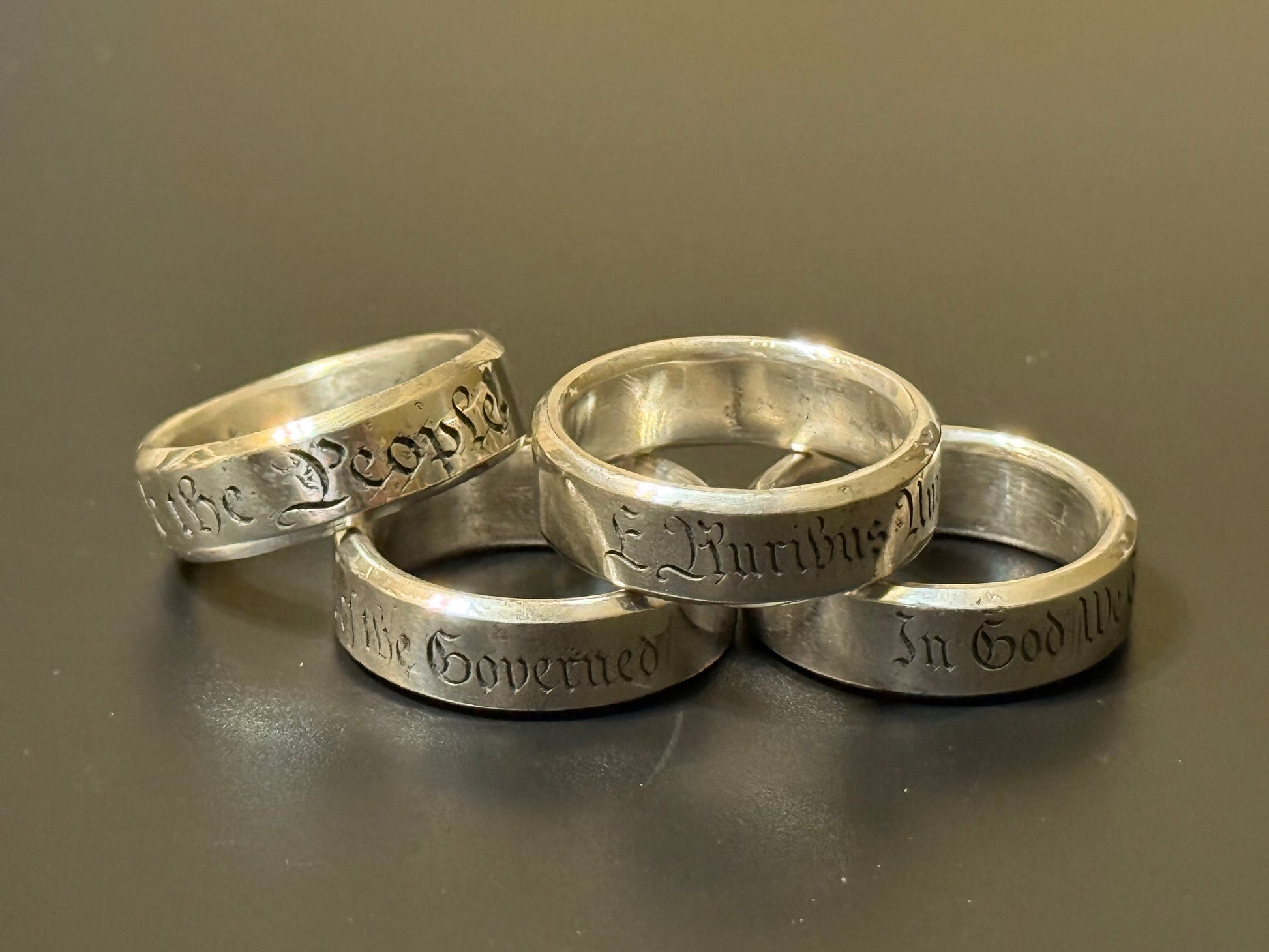 Collection of handmade engraved silver bands with USA Patriot Theme