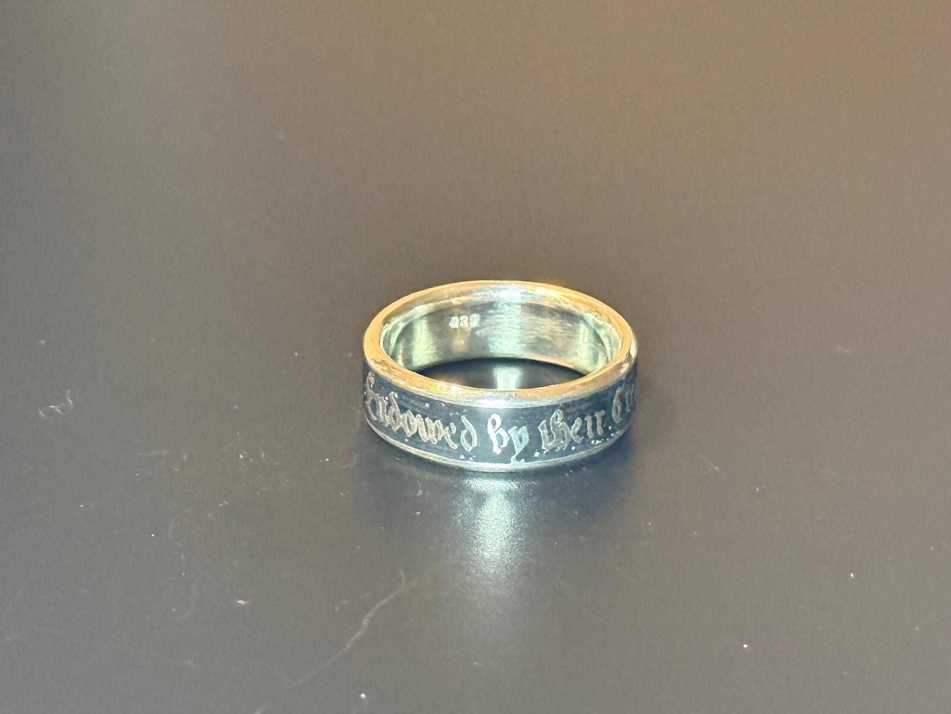 Endowed By Their Creator text embedded in silver band