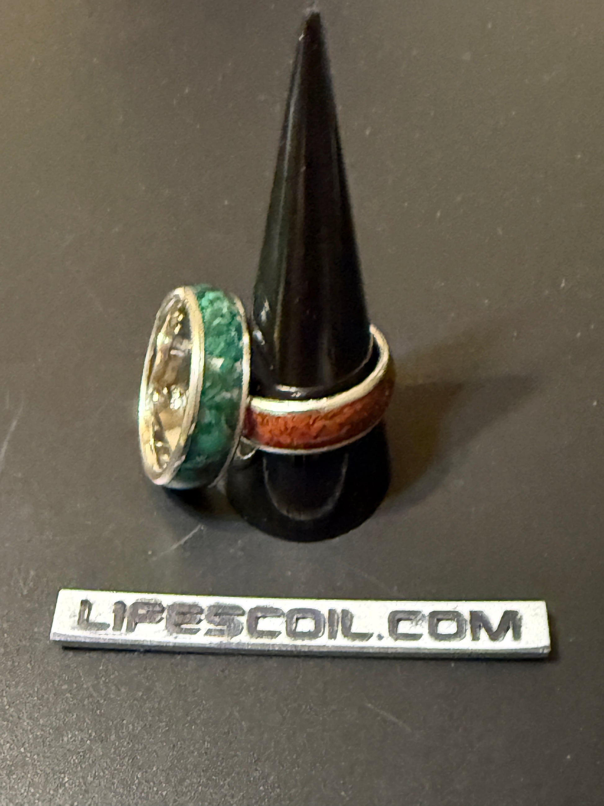 Two handmade silver rings with natural stone, one jasper and one malachite, embedded in band
