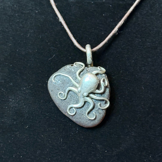 Large brown sea glass pendant with a silver Octopus.