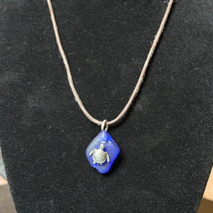 Small blue sea glass pendant with a silver sea turtle.
