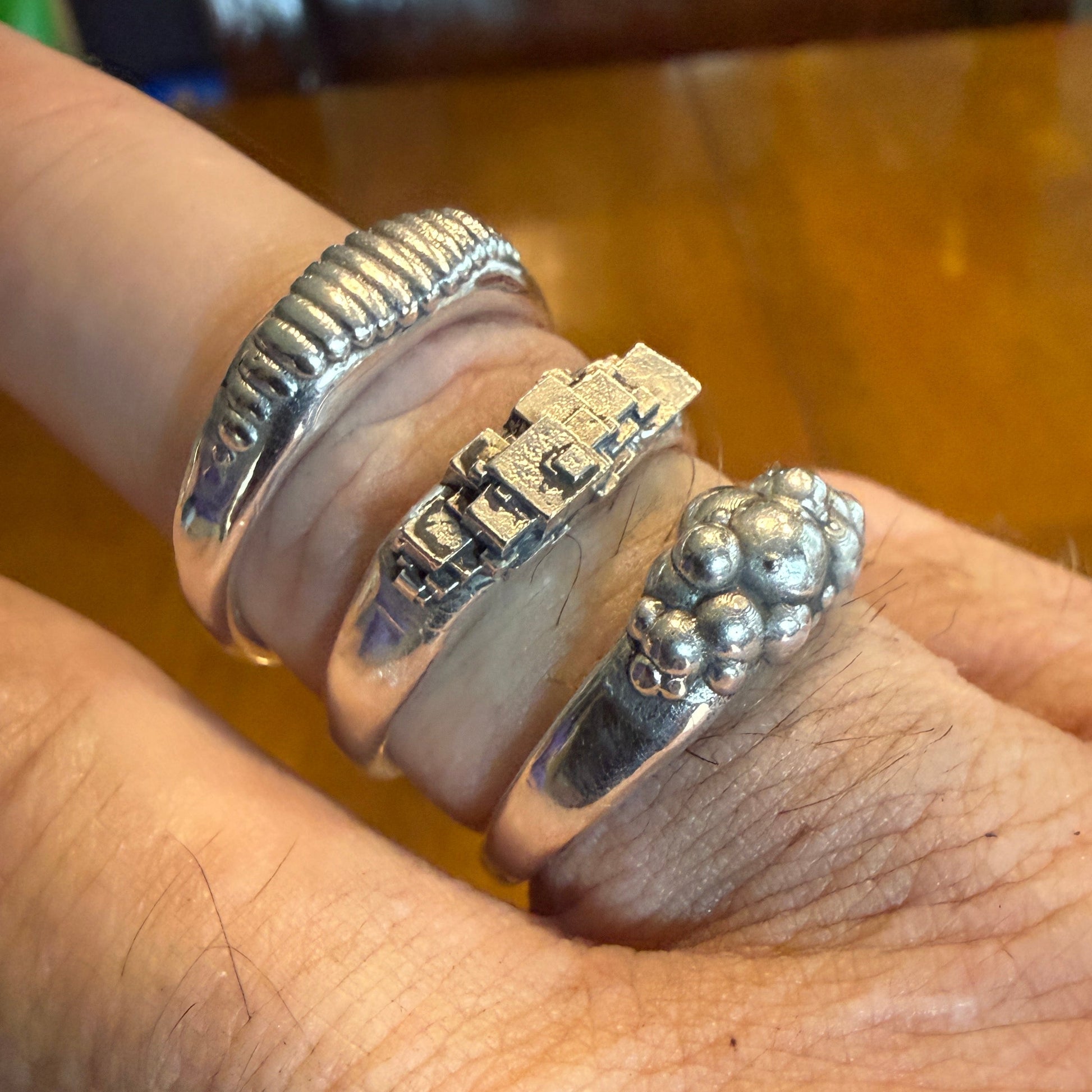 Ellipse, cube and sphere shapes clustered on narrow signet rings