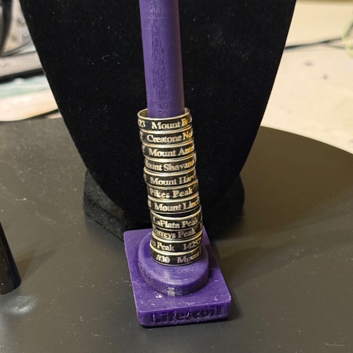 Multiple 14er summit rings on prototype ring stand