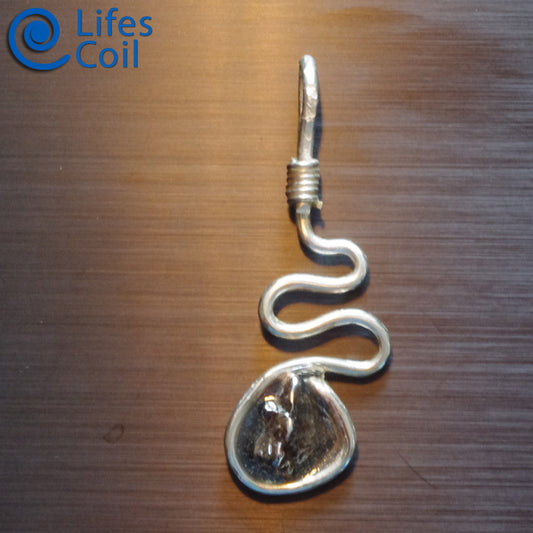 Handmade silver wire pendant with natural meteorite